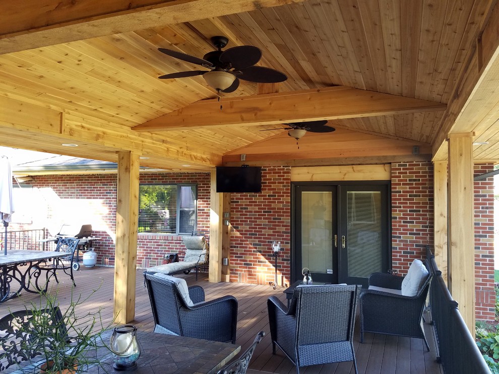 Large backyard deck photo with a roof extension