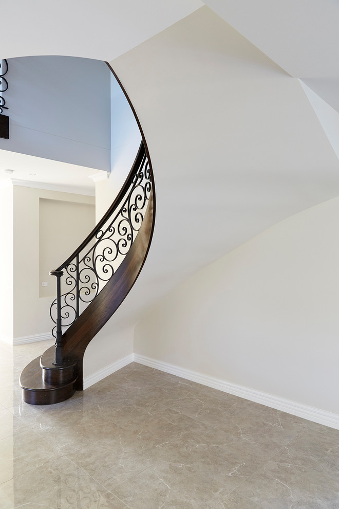 Inspiration for a large traditional wood curved staircase in Melbourne with wood risers and wood railing.