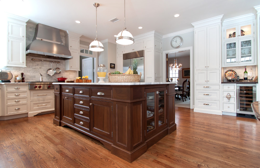 Example of a large transitional kitchen design in DC Metro with beaded inset cabinets, white cabinets, marble countertops, white backsplash, subway tile backsplash, stainless steel appliances and an island