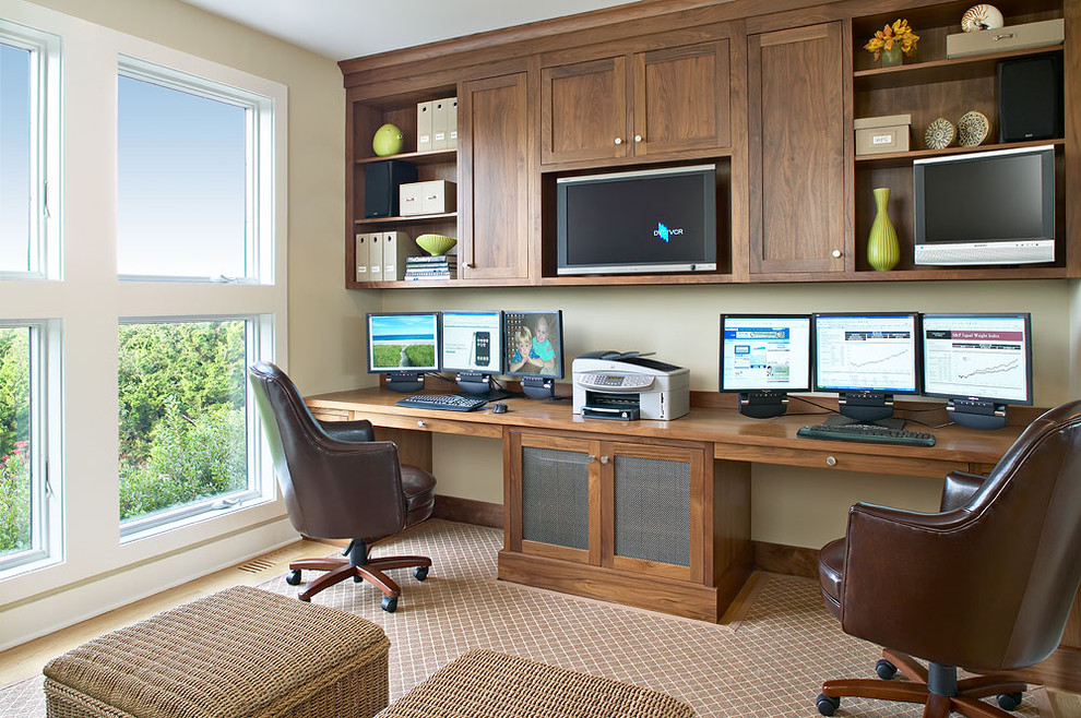 This is an example of a beach style home office in New York with a built-in desk.