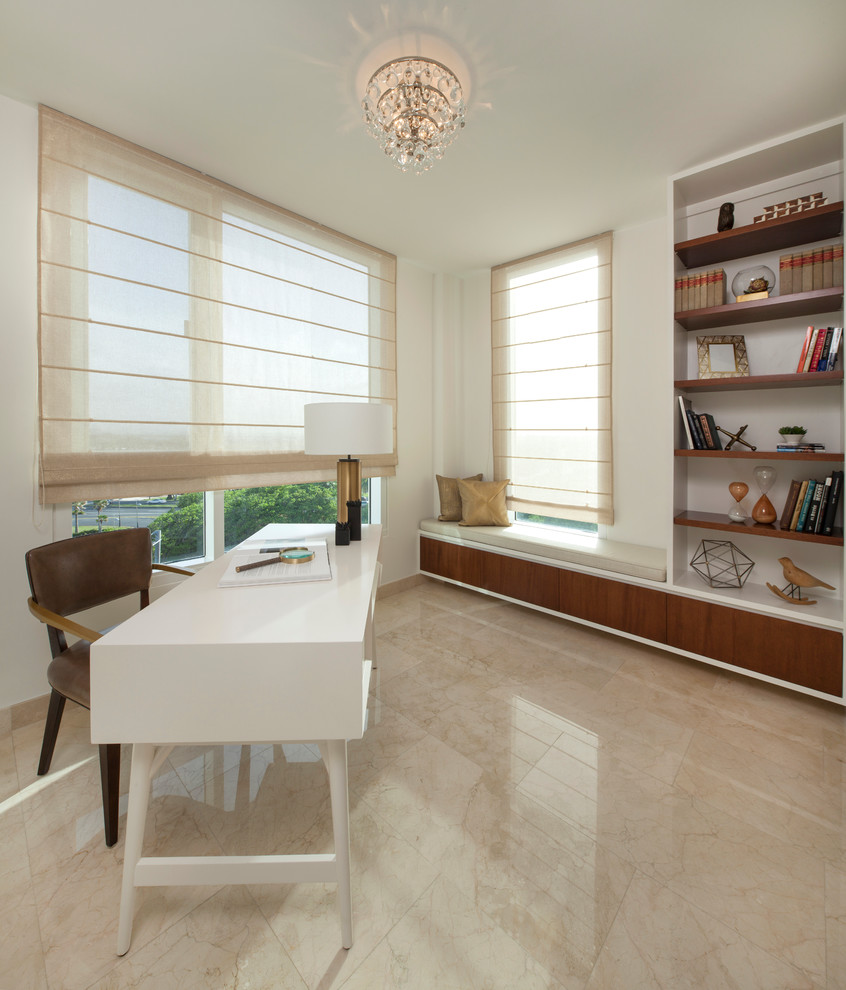 Photo of a mid-sized modern study room in Other with beige walls, marble floors, a freestanding desk and no fireplace.