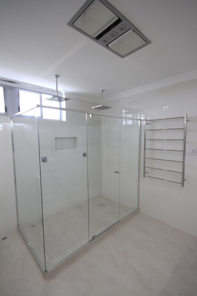 Design ideas for a large modern bathroom in Perth with an undermount sink, flat-panel cabinets, white cabinets, a double shower, white tile, ceramic tile, white walls and ceramic floors.