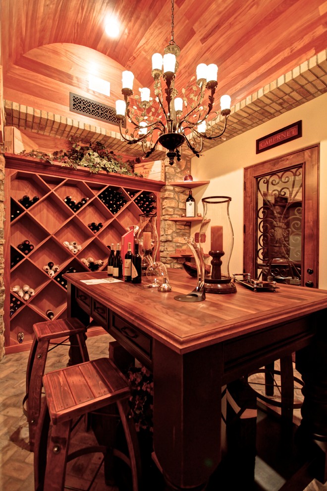 Inspiration for a mid-sized traditional wine cellar in Phoenix with limestone floors and diamond bins.