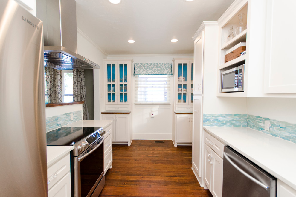 Small transitional galley eat-in kitchen in Dallas with recessed-panel cabinets, white cabinets, blue splashback, ceramic splashback, stainless steel appliances, medium hardwood floors, no island and an undermount sink.
