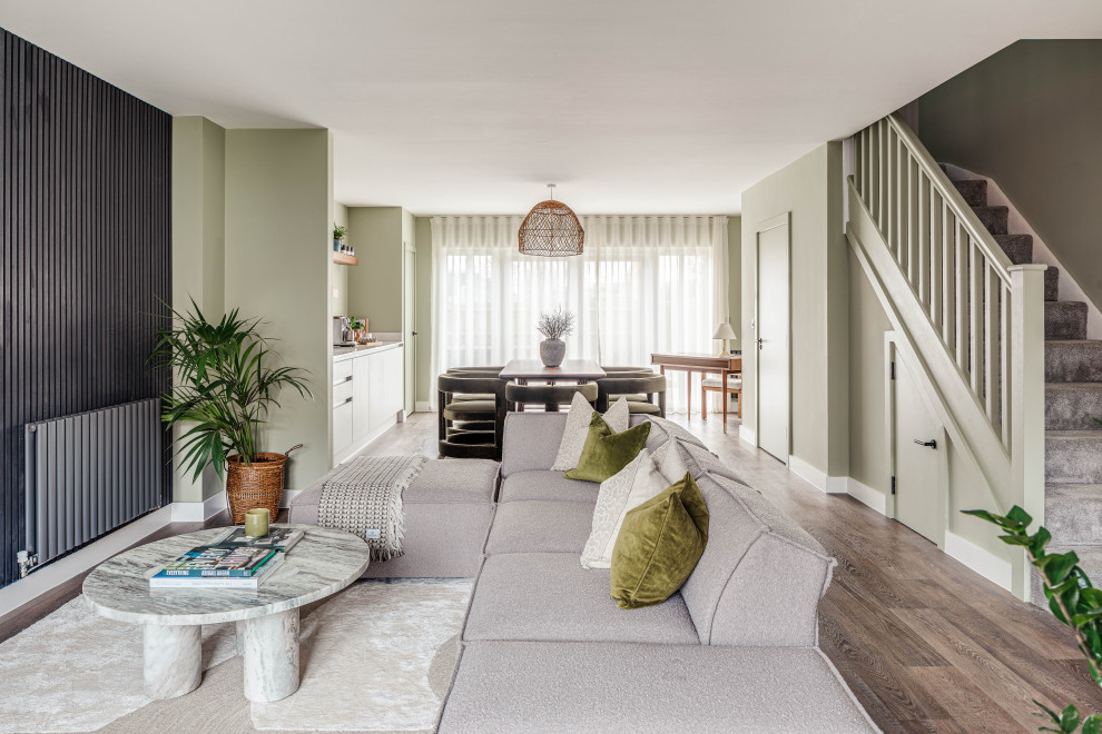 Photo of a classic open plan living room in Buckinghamshire with green walls, dark hardwood flooring and brown floors.