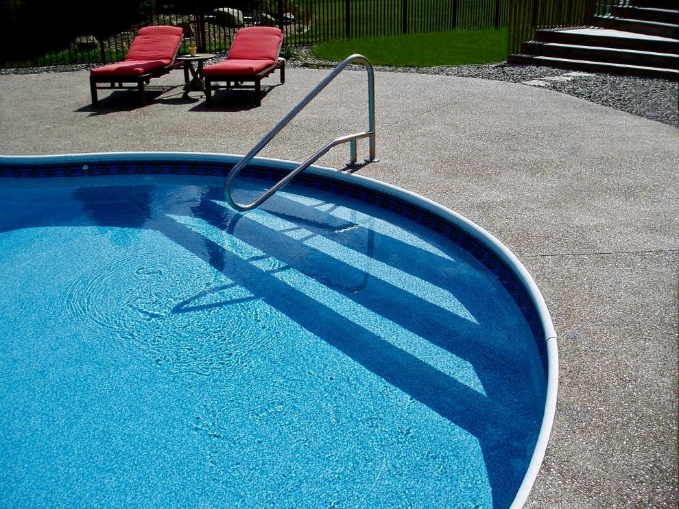 Pool - large backyard custom-shaped pool idea in Grand Rapids