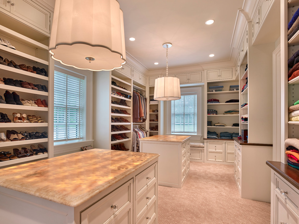 Photo of a classic wardrobe in Wilmington with beaded cabinets, white cabinets and carpet.