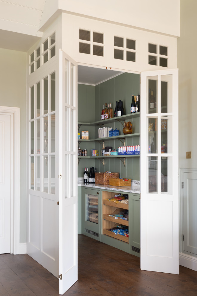 Design ideas for a large classic l-shaped kitchen pantry in London with shaker cabinets, quartz worktops, integrated appliances, dark hardwood flooring, brown floors, a chimney breast, green cabinets, green splashback, tonge and groove splashback and white worktops.