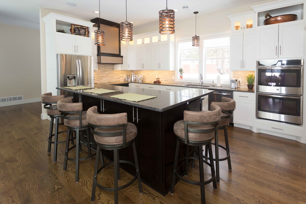 Inspiration for a mid-sized transitional l-shaped kitchen in San Diego with an undermount sink, recessed-panel cabinets, white cabinets, quartz benchtops, beige splashback, porcelain splashback, stainless steel appliances, dark hardwood floors and with island.