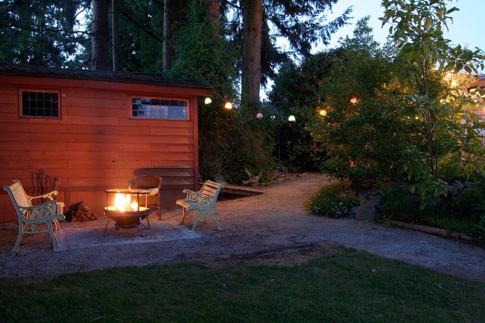 Inspiration for an eclectic garden in Vancouver with a fire feature.