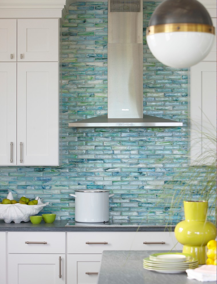 Beach style eat-in kitchen in Boston with shaker cabinets, white cabinets, glass tile splashback, granite benchtops, blue splashback, stainless steel appliances and with island.