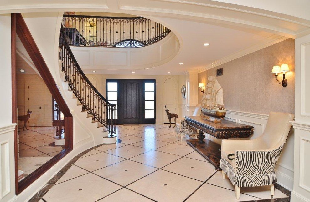 This is an example of a large traditional wood curved staircase in San Diego with painted wood risers.