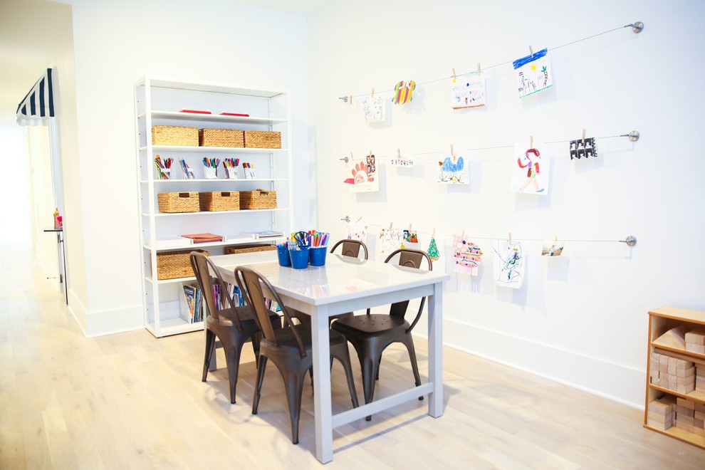 Inspiration for a mid-sized modern gender-neutral kids' playroom for kids 4-10 years old in New York with white walls and light hardwood floors.