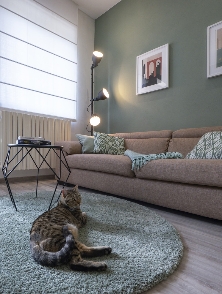 Photo of a small contemporary open concept living room in Milan with green walls, linoleum floors, a corner fireplace, a plaster fireplace surround and a built-in media wall.