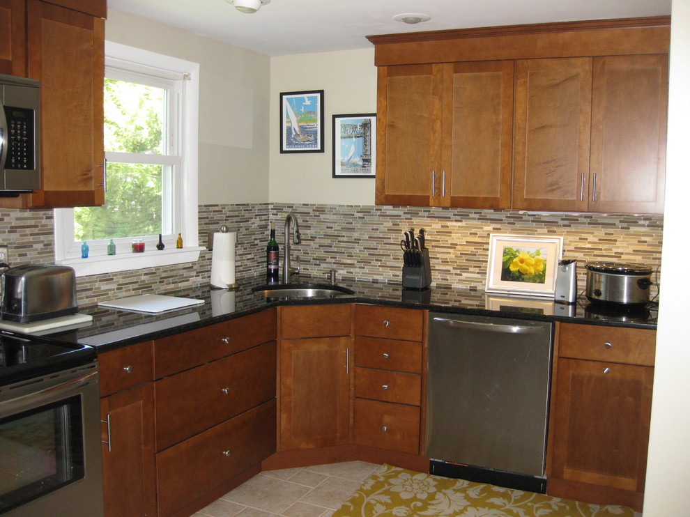 Inspiration for a transitional u-shaped travertine floor and beige floor eat-in kitchen remodel in Boston with an undermount sink, medium tone wood cabinets, granite countertops, stainless steel appliances, a peninsula, shaker cabinets, brown backsplash, matchstick tile backsplash and black countertops