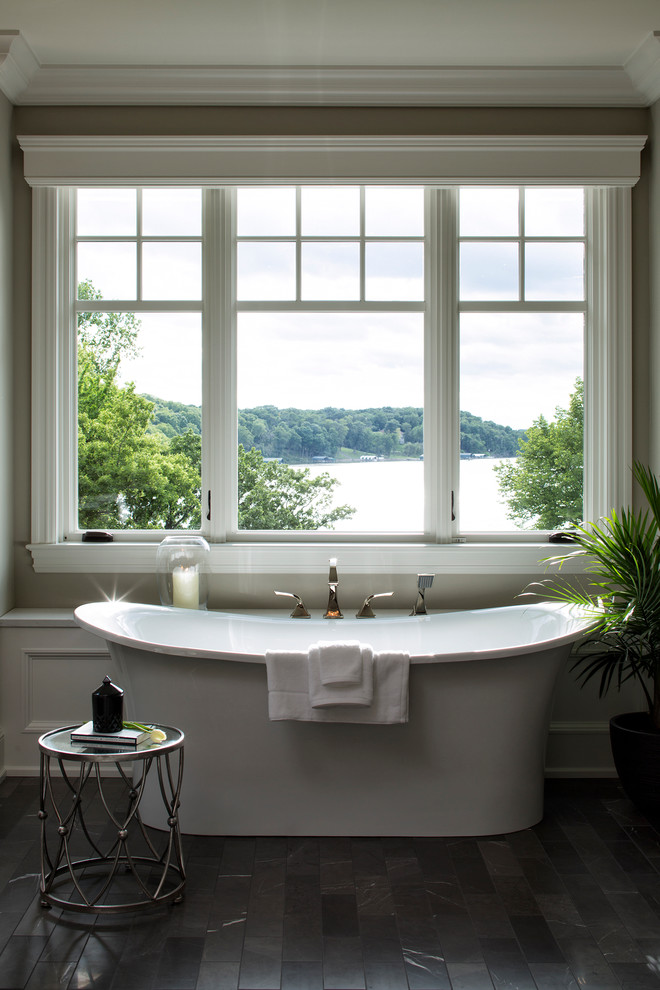 Design ideas for a large transitional master bathroom in Minneapolis with dark wood cabinets, a freestanding tub and beige walls.