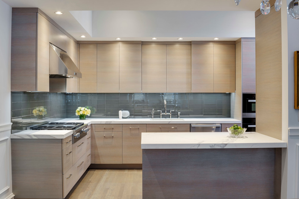 Photo of a mid-sized modern l-shaped eat-in kitchen in Boston with an undermount sink, flat-panel cabinets, light wood cabinets, brown splashback, subway tile splashback, stainless steel appliances, medium hardwood floors and a peninsula.