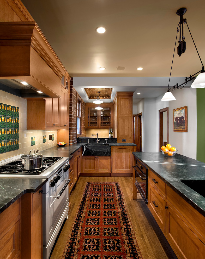 Inspiration for a traditional kitchen in Denver with an integrated sink, recessed-panel cabinets, soapstone benchtops, beige splashback, subway tile splashback and stainless steel appliances.