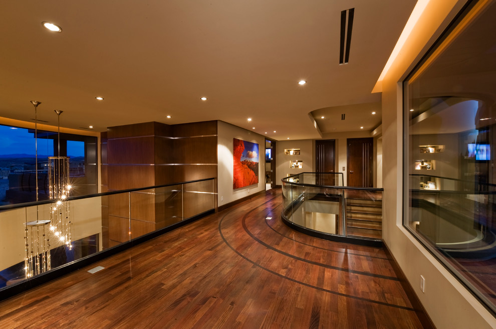 Photo of a contemporary hallway in Las Vegas with beige walls and dark hardwood floors.