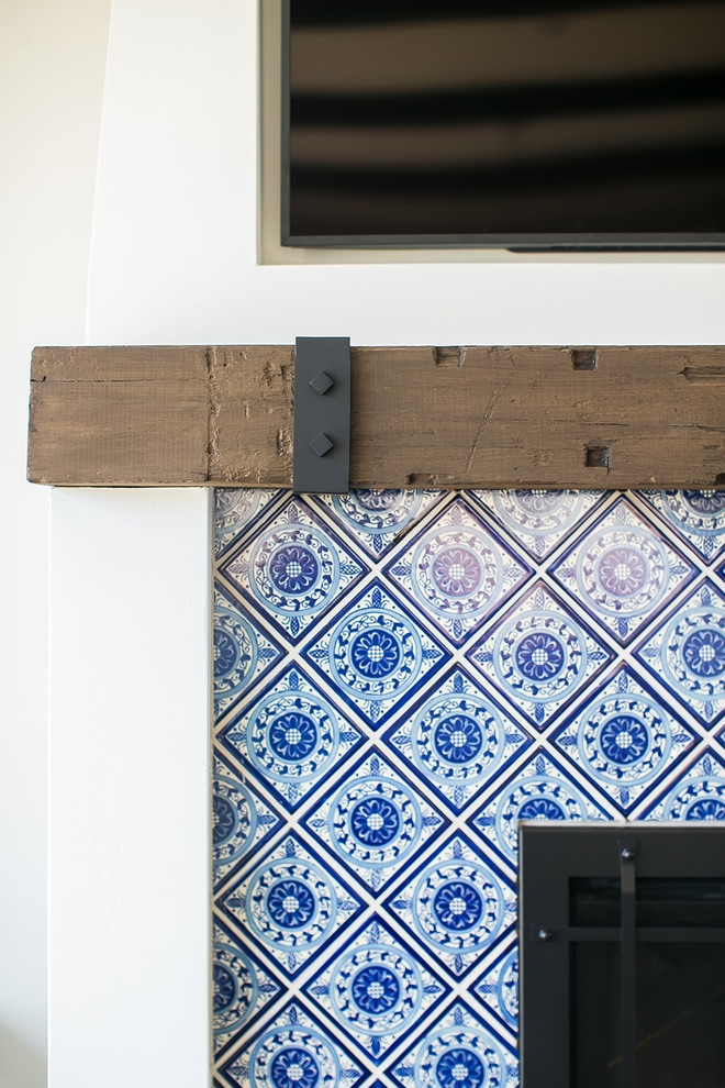 Example of a beach style medium tone wood floor family room design in San Diego with gray walls, a standard fireplace, a tile fireplace and a wall-mounted tv