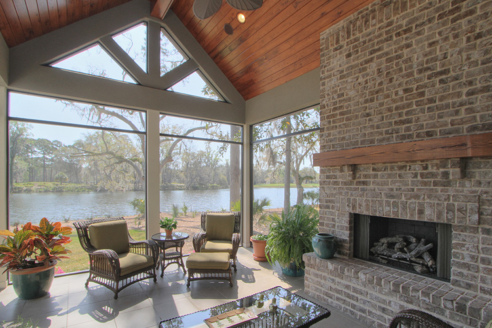 Design ideas for a large traditional sunroom in Atlanta with concrete floors, a standard fireplace, a brick fireplace surround and a standard ceiling.