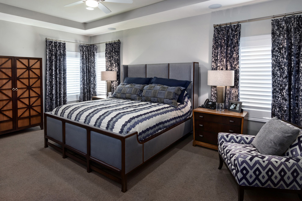 Inspiration for a mid-sized transitional master bedroom in Omaha with grey walls, carpet, no fireplace and grey floor.