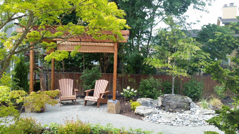 Inspiration for a large asian backyard patio in Portland with a water feature, a pergola and stamped concrete.