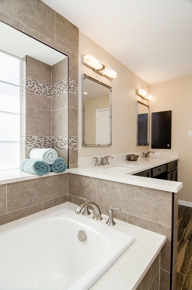 This is an example of a mid-sized transitional master bathroom in Dallas with an undermount sink, shaker cabinets, dark wood cabinets, solid surface benchtops, an alcove tub, an open shower, a one-piece toilet, brown tile, ceramic tile, beige walls and ceramic floors.