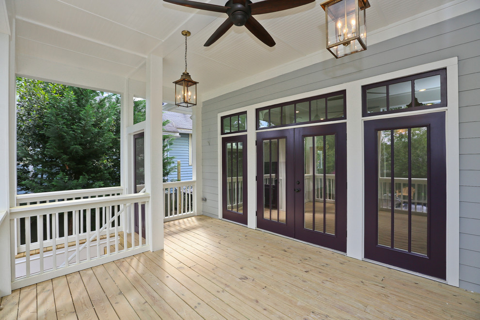 Mid-sized arts and crafts backyard deck in Atlanta with a roof extension.