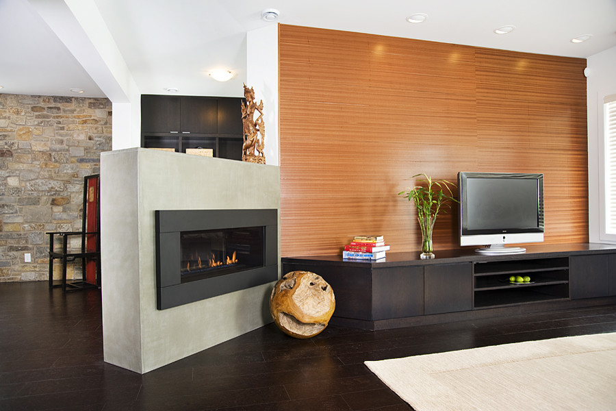This is an example of a large contemporary open concept family room in Calgary with white walls, dark hardwood floors and a ribbon fireplace.