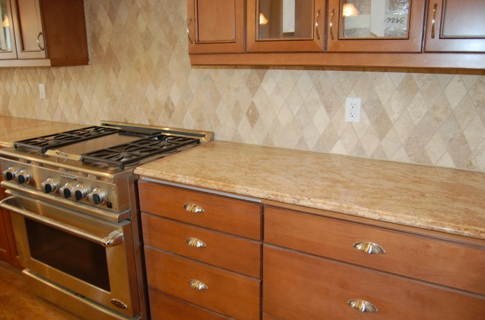 Kitchen - medium tone wood floor kitchen idea in Seattle with flat-panel cabinets, medium tone wood cabinets, granite countertops, beige backsplash and an island