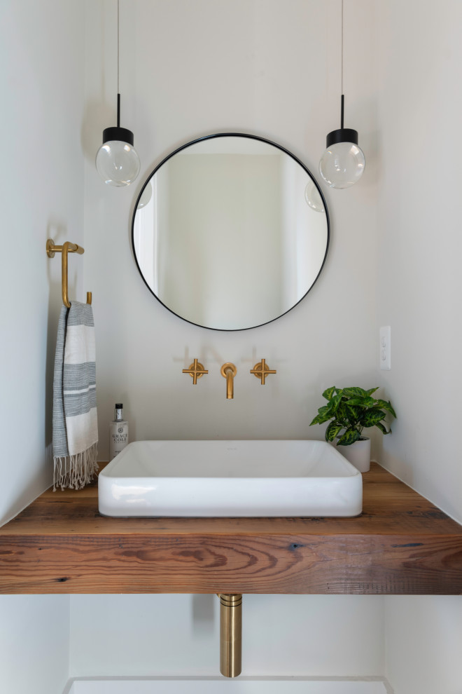 Design ideas for a large country powder room in DC Metro with medium wood cabinets, a drop-in sink, wood benchtops, brown benchtops and a floating vanity.