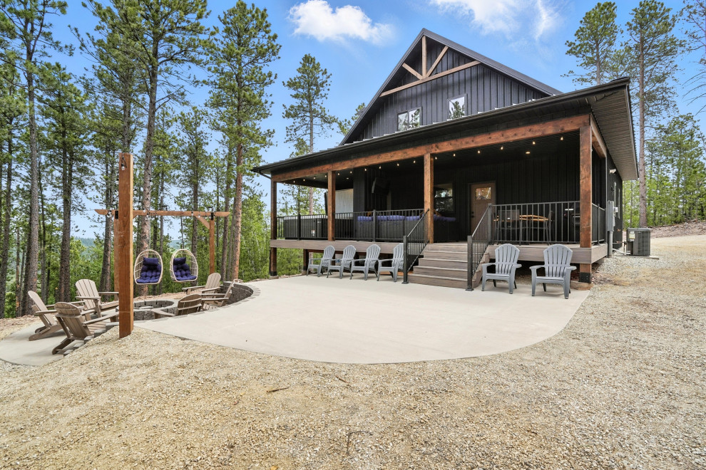 Inspiration for a rustic black two-story metal and board and batten exterior home remodel in Other with a metal roof and a black roof