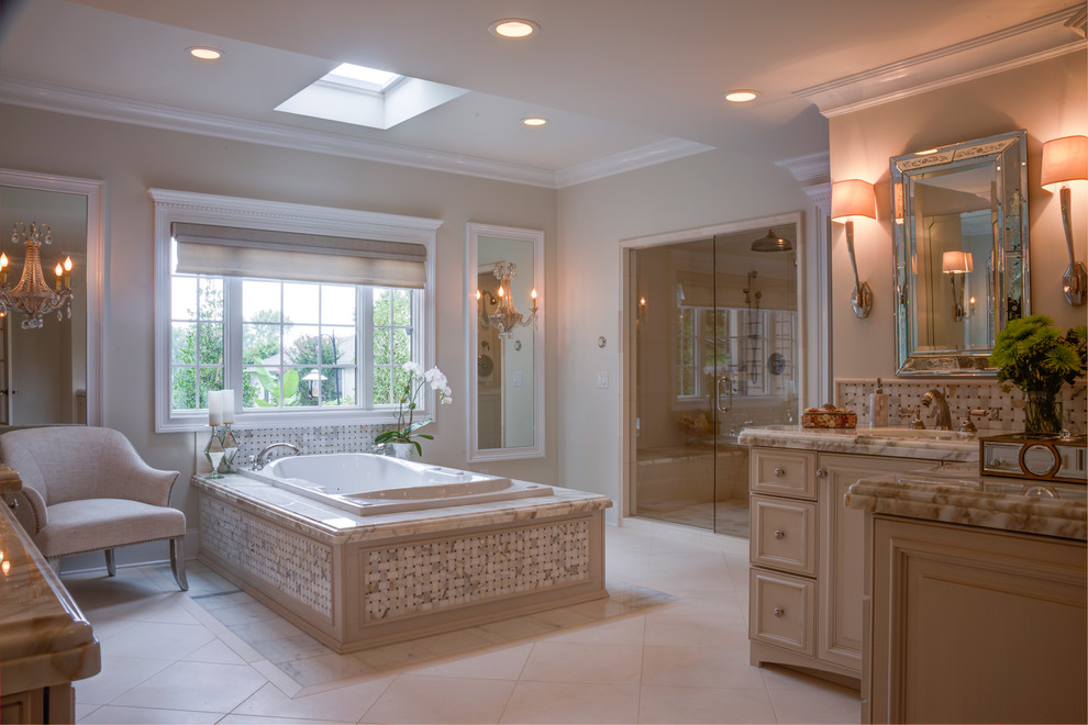 Traditional bathroom in Other with an undermount sink, raised-panel cabinets, beige cabinets, marble benchtops, a freestanding tub, a one-piece toilet, beige tile, stone tile, beige walls, marble floors and with a sauna.