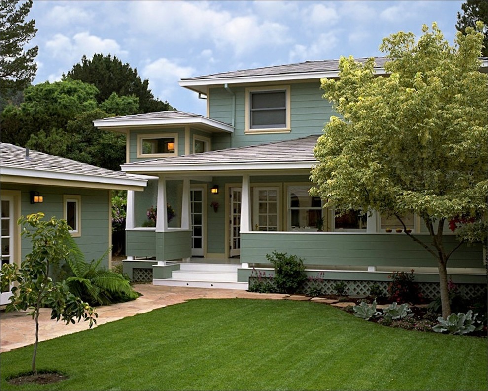 Photo of a mid-sized traditional backyard verandah in San Francisco with a roof extension and natural stone pavers.