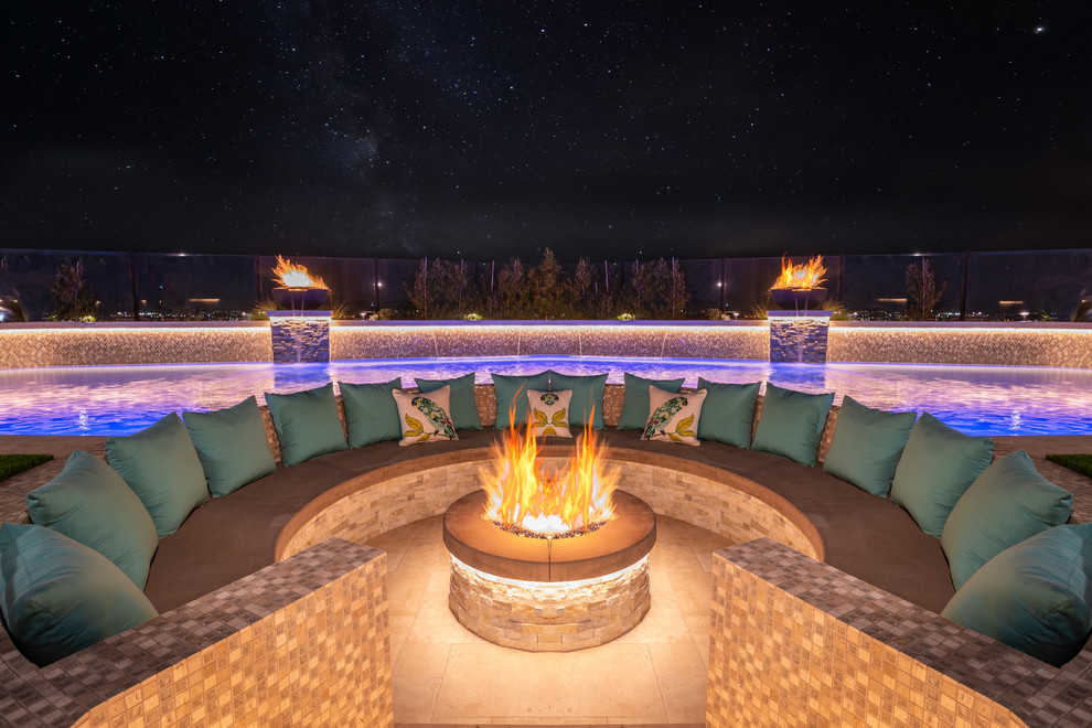 Contemporary backyard patio in Orange County with a fire feature, tile and no cover.