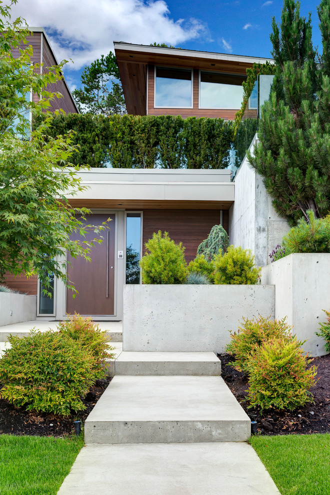 This is an example of a large contemporary front yard garden in Vancouver with a garden path and concrete pavers.