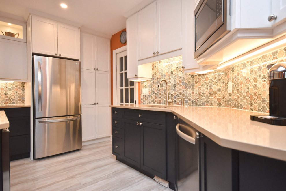 Kitchen - mid-sized transitional l-shaped vinyl floor and beige floor kitchen idea in Ottawa with a double-bowl sink, shaker cabinets, white cabinets, quartzite countertops, multicolored backsplash, mosaic tile backsplash, stainless steel appliances, an island and beige countertops
