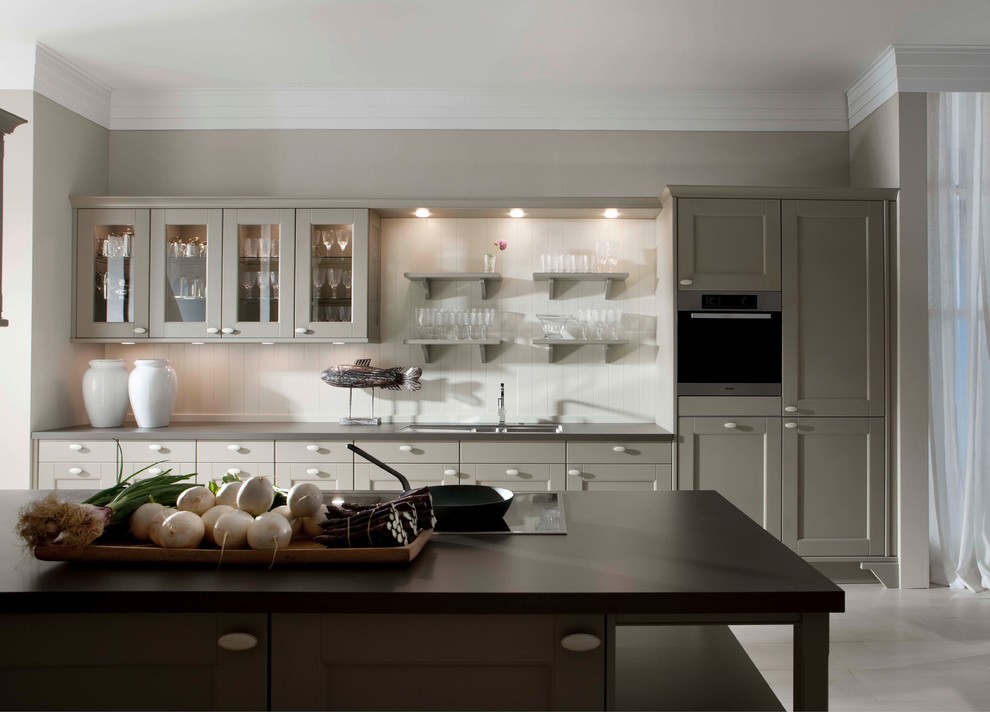 Design ideas for a large traditional galley eat-in kitchen in New York with a double-bowl sink, shaker cabinets, grey cabinets, stainless steel appliances and light hardwood floors.