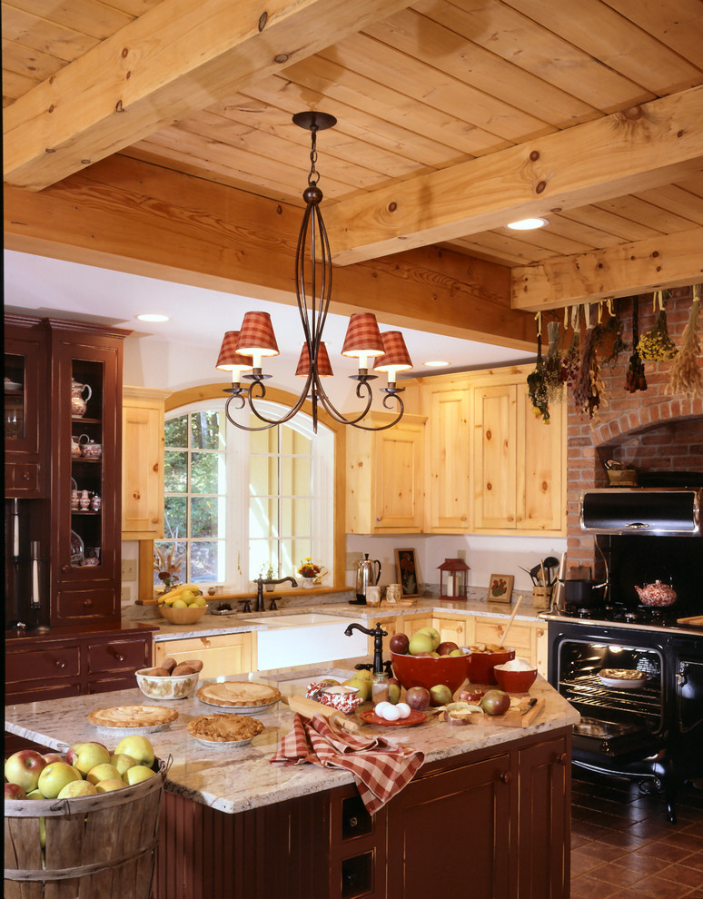 This is an example of a traditional l-shaped eat-in kitchen in Burlington with a farmhouse sink, flat-panel cabinets, light wood cabinets and with island.