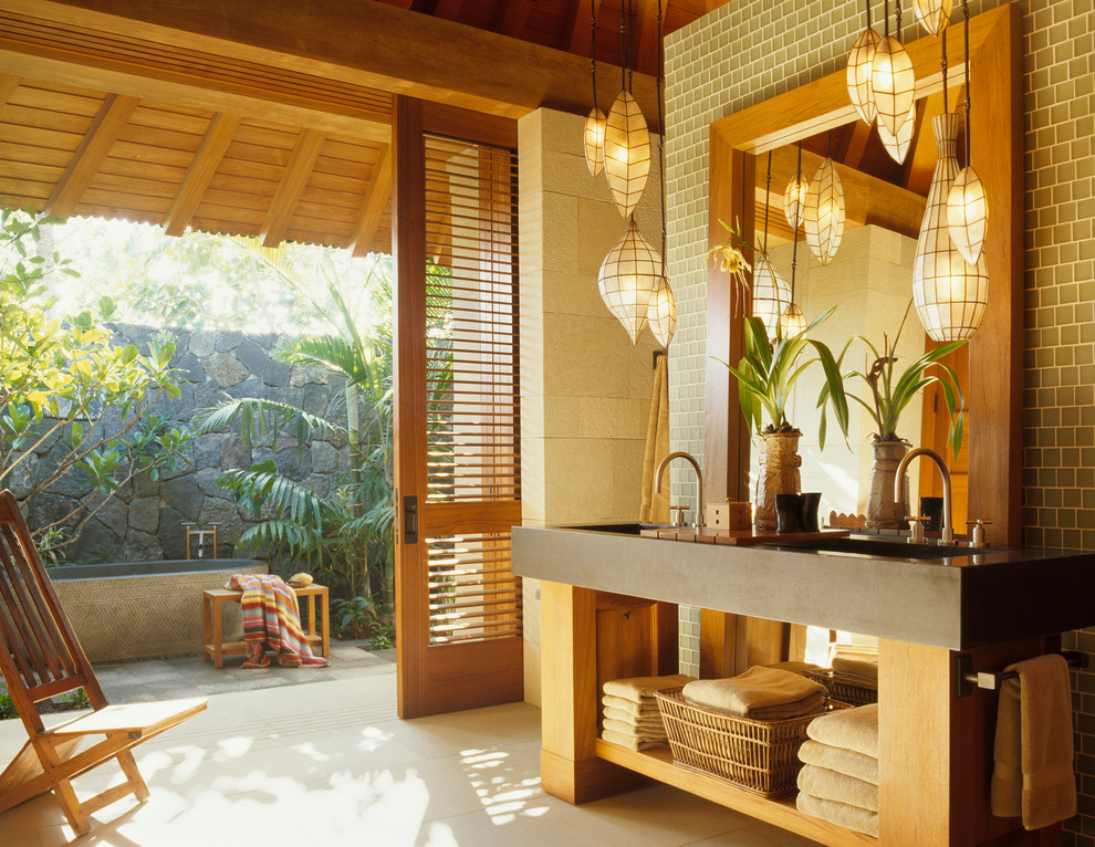 Inspiration for a tropical bathroom in San Francisco with concrete benchtops.