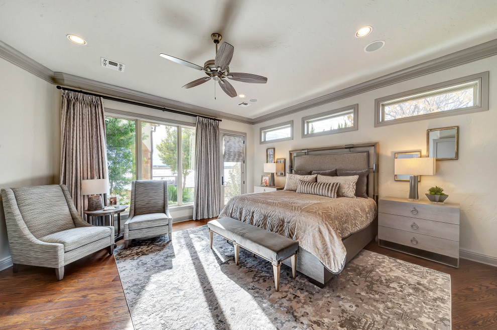 Photo of an expansive transitional master bedroom in Dallas with grey walls, medium hardwood floors and brown floor.
