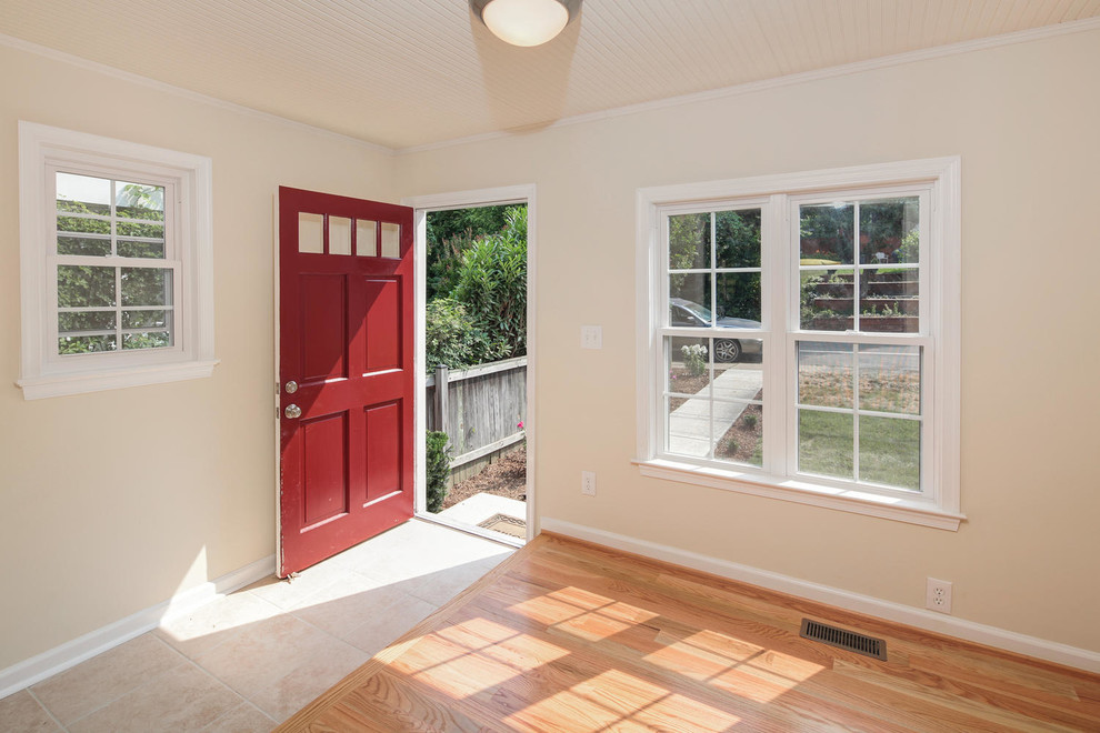 Elegant light wood floor entryway photo in DC Metro with beige walls and a red front door