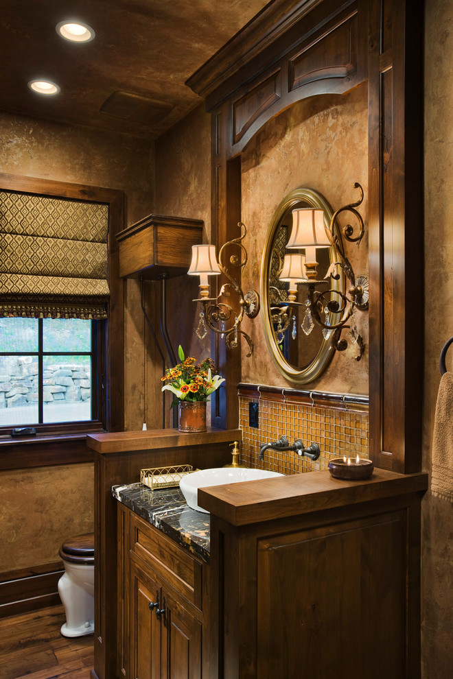 Photo of a country powder room in Other with a vessel sink.