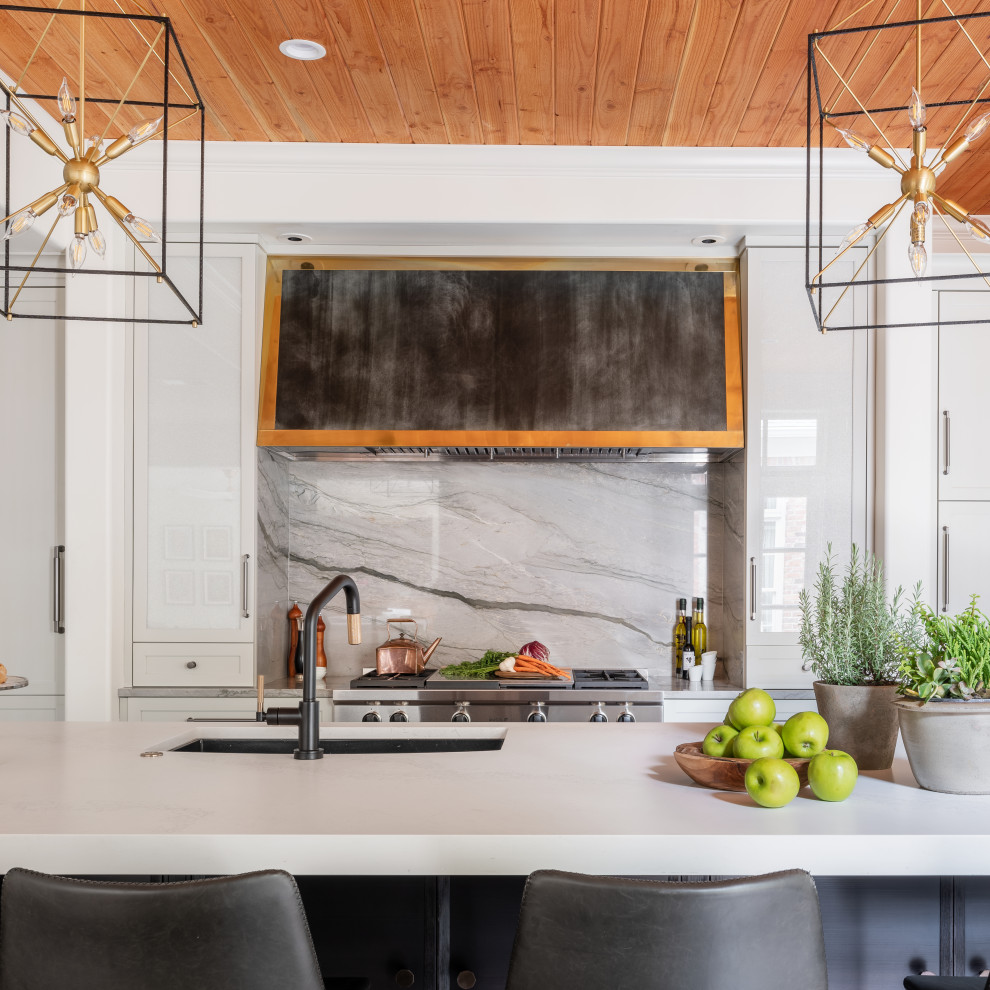 Example of a large tuscan kitchen design with recessed-panel cabinets, white cabinets, granite countertops, gray backsplash, marble backsplash and white countertops