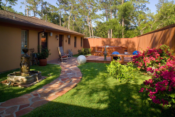 Water fountain deck - mid-sized rustic backyard stone water fountain deck idea in Houston with no cover