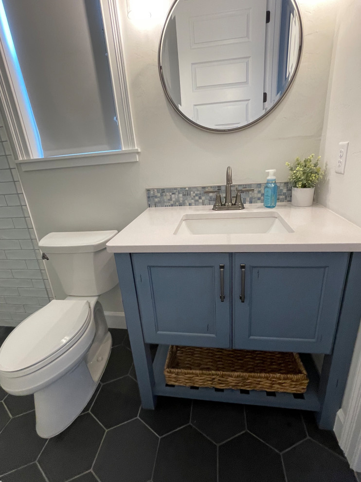 Inspiration for a nautical family bathroom with shaker cabinets, blue cabinets, blue tiles, glass sheet walls, grey walls, slate flooring, a submerged sink, quartz worktops, black floors, a hinged door, white worktops, a single sink and a built in vanity unit.