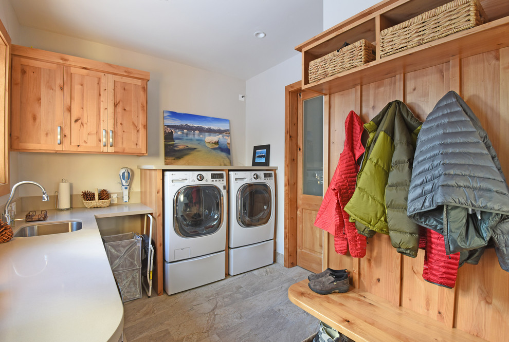 Mid-sized arts and crafts l-shaped utility room in Other with an undermount sink, shaker cabinets, light wood cabinets, quartz benchtops, white walls, a side-by-side washer and dryer and grey floor.