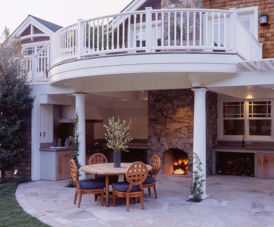 This is an example of a mid-sized traditional backyard patio in San Francisco with an outdoor kitchen, natural stone pavers and a roof extension.