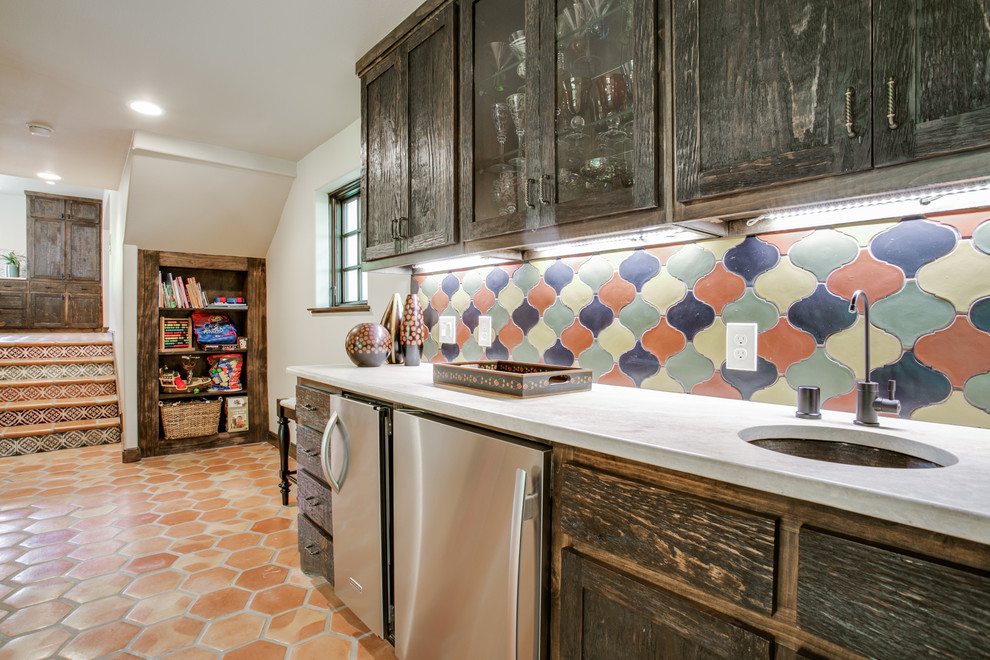 Large mediterranean u-shaped eat-in kitchen in Dallas with an undermount sink, shaker cabinets, distressed cabinets, quartz benchtops, multi-coloured splashback, porcelain splashback, stainless steel appliances, terra-cotta floors and with island.